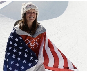 Arielle Gold wrapped in the American flag after winning Olympic bronze