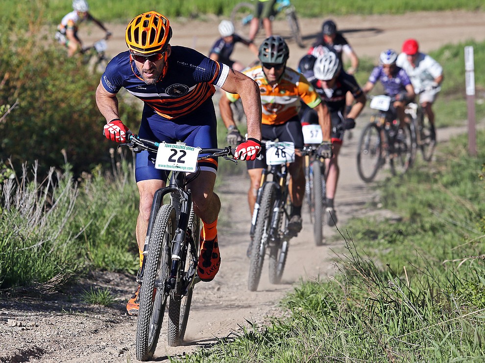 Jeremy MacGray leading a pack of riders up a singletrack climb