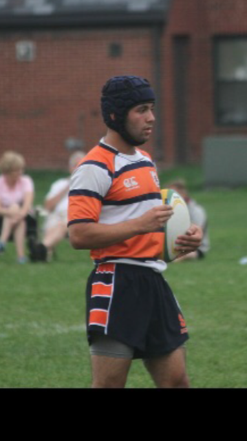 Karim Yamout in scrum cap and rugby kit holding a ball on the pitch